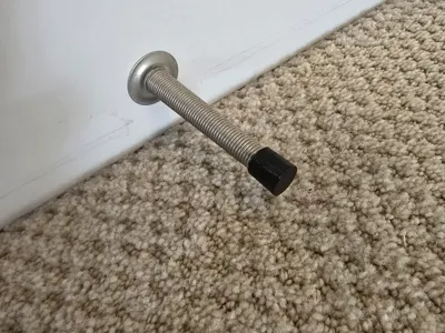 Screw wire door stop cover