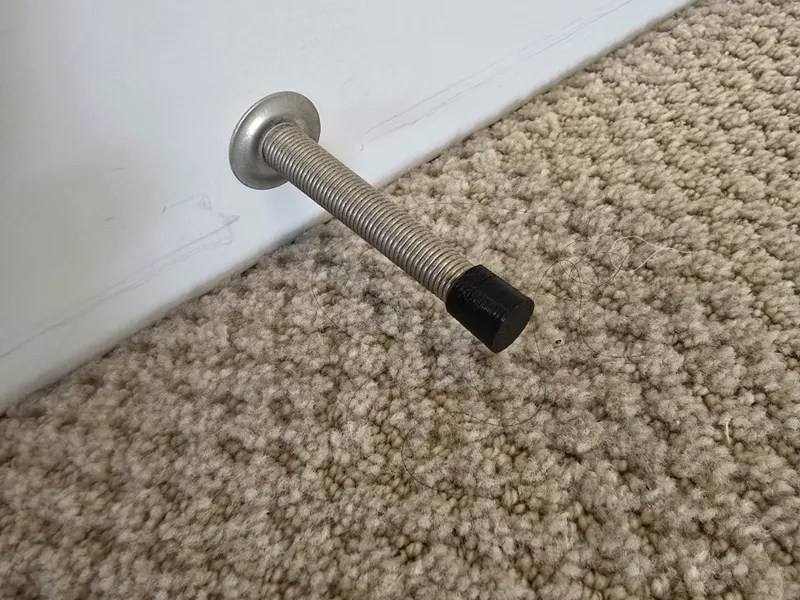 Screw wire door stop cover