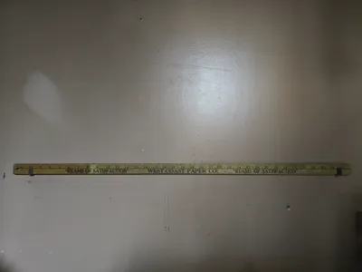 Wall mount display for yardstick or ruler