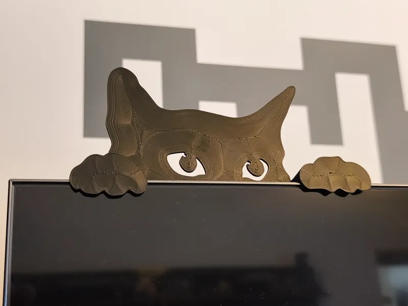 Spying cat  - on the monitor edge