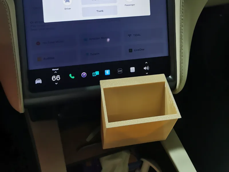 Half size Tesla Model X under screen trash bin