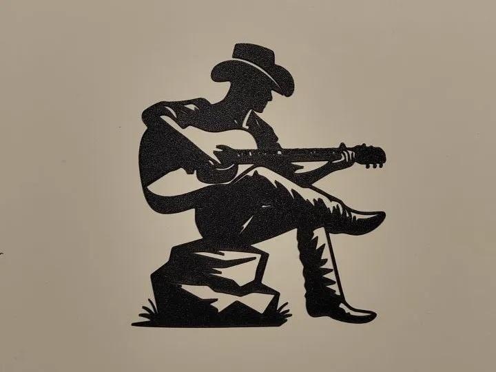 Silhouette cowboy a la guitare
