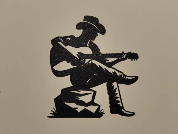 Silhouette cowboy a la guitare