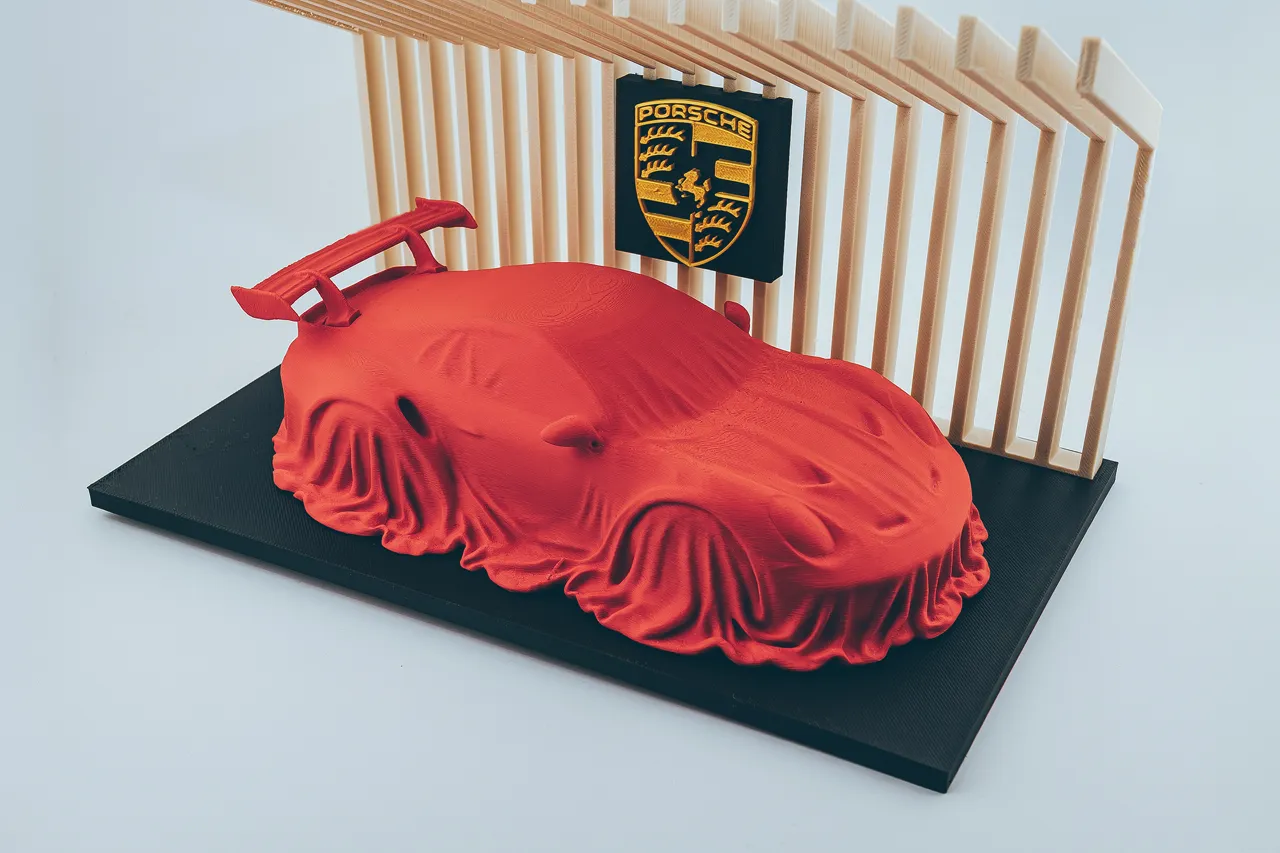Porsche 911 GT3 RS covered on a diplay stand. view 4