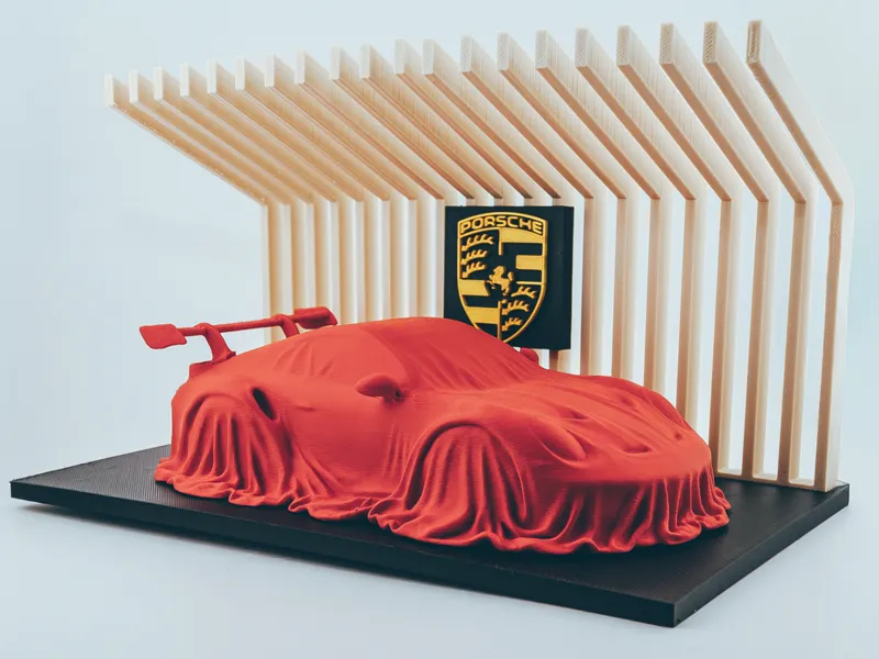 Porsche 911 GT3 RS covered on a diplay stand.