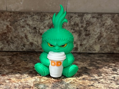 Grinch holding Dunkin cup