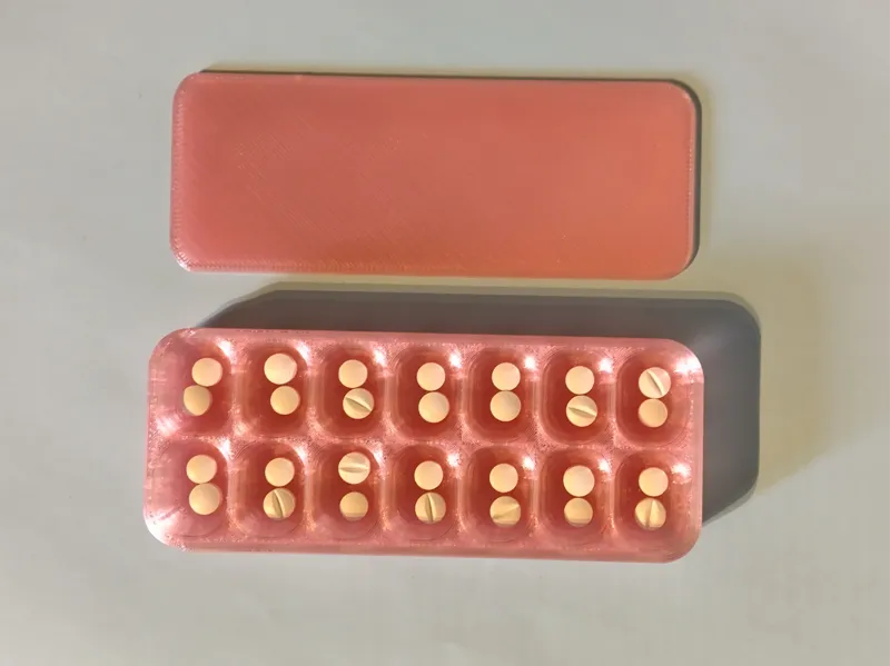 Pill box with 14 compartments and a sliding cover