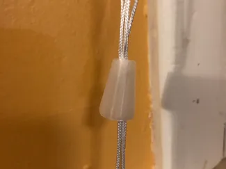 Curtain/Blinds string holder