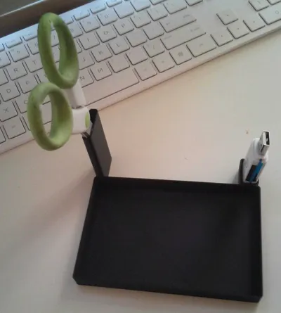 Desk organizer for USB, scissors, and camera.