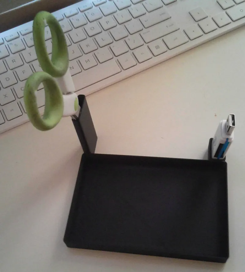 Desk organizer for USB, scissors, and camera.