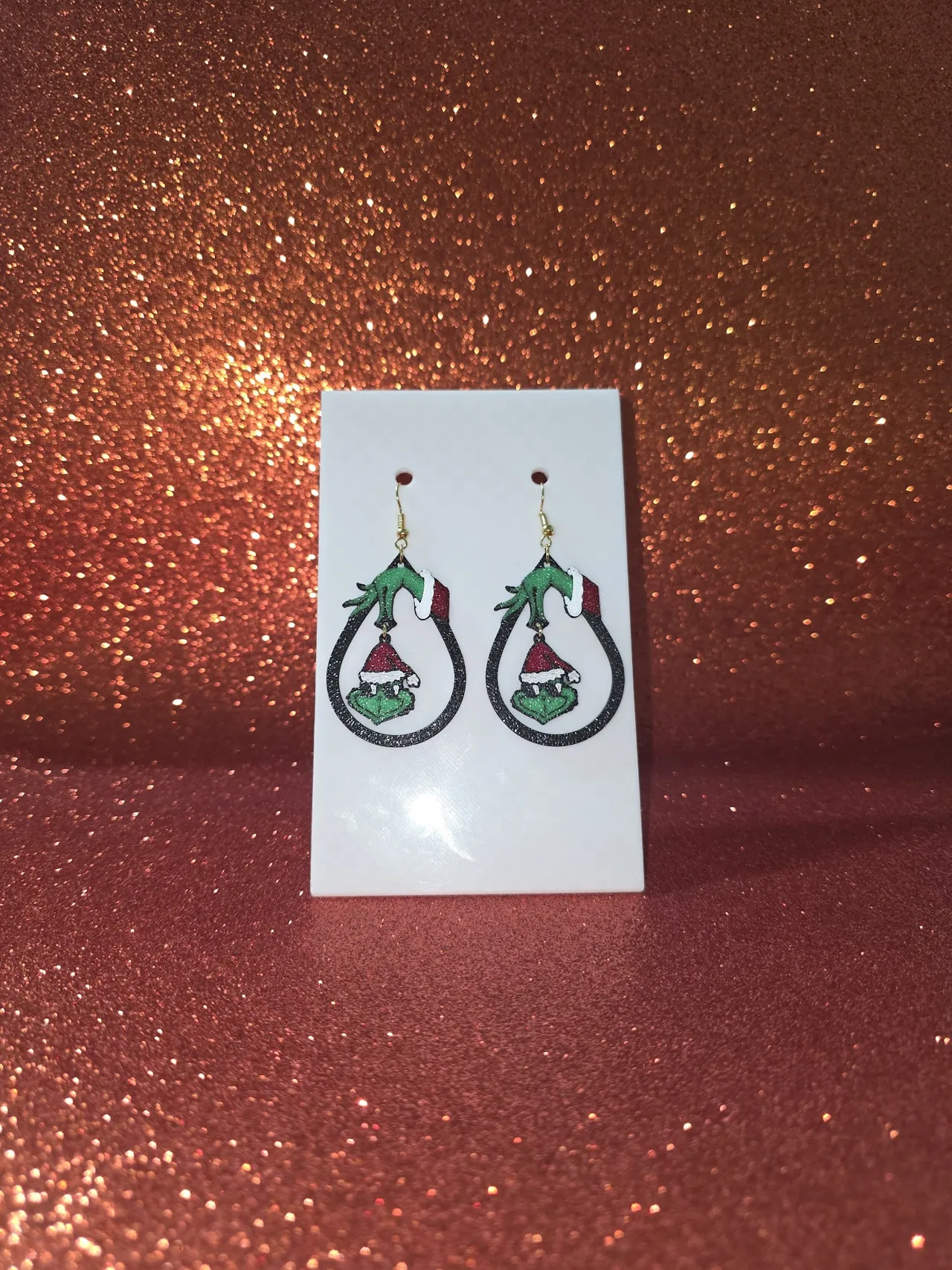 Hanging Grinch face earrings view 2