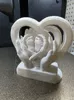 feet in 2 hands memorial with plaque