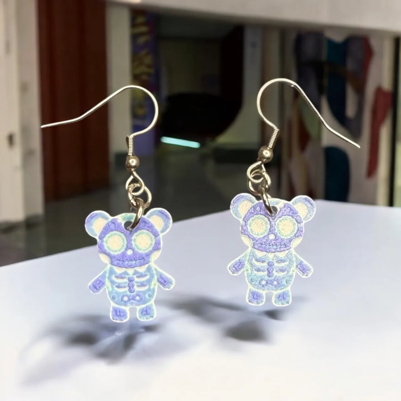 Tiny Skellington teddy bear earrings, Hueforge view 2