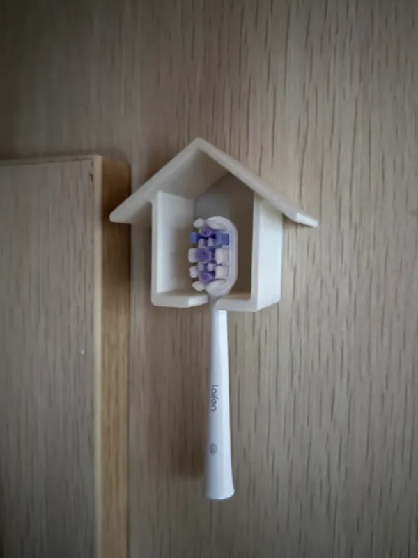 Crochet anti-poussière pour brosse à dents