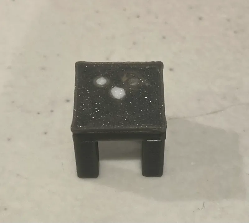 A table to the hut to Cube with a Pyramid on head 