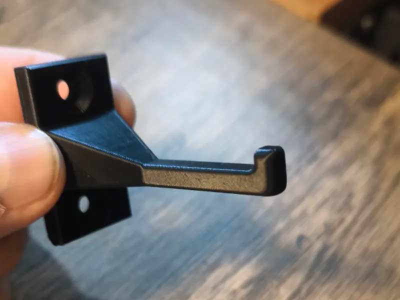Longer hook for hanging the dustpan and brush