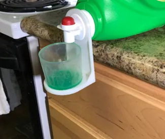 Laundry detergent cup holder