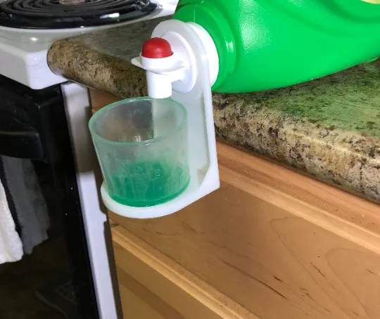 Laundry detergent cup holder