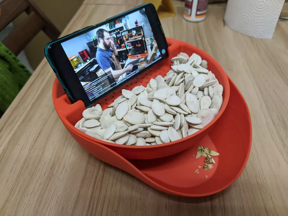 Snacks serving bowl with waste compartment and phone stand Shared by