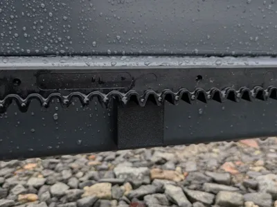 Toothed rack cover for entrance gate.