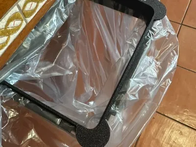 DOOR-MOUNTED TRASH BAG HOLDER