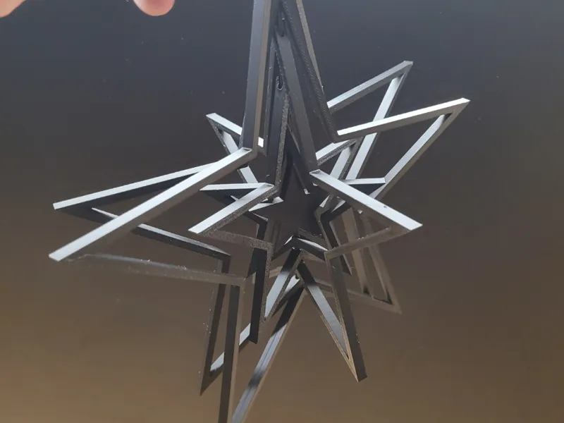 Articulated star decoration with a stand or a hook
