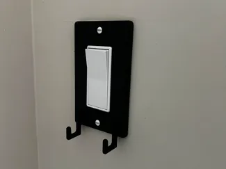 Light switch cover with hooks