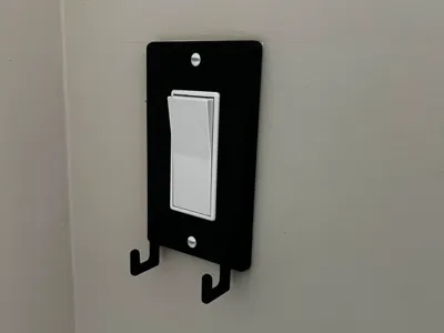 Light switch cover with hooks