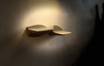 Letrero o emblema decorativo: ⏜ Dunetta ⏝ — vista de referencia 4