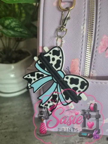 Accesorio para sujetar ligas de cabello: Cow Print Bow Hair Tie Holder Keychain — vista de referencia 2