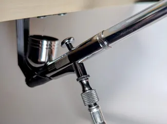 Under shelf airbrush holder