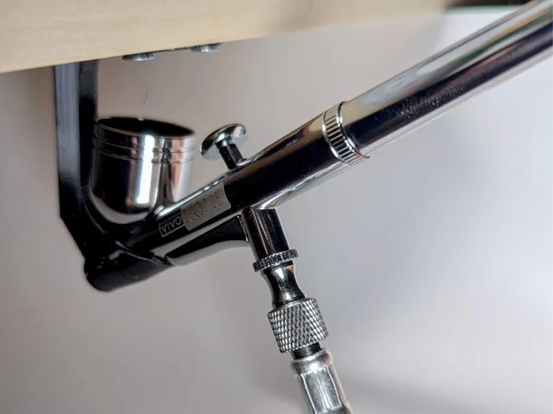 Under shelf airbrush holder