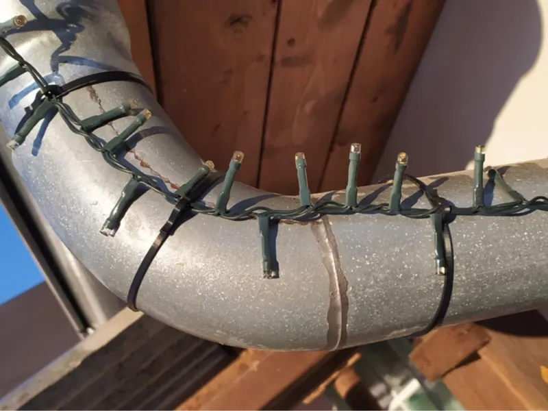 Gutter downpipe light holder