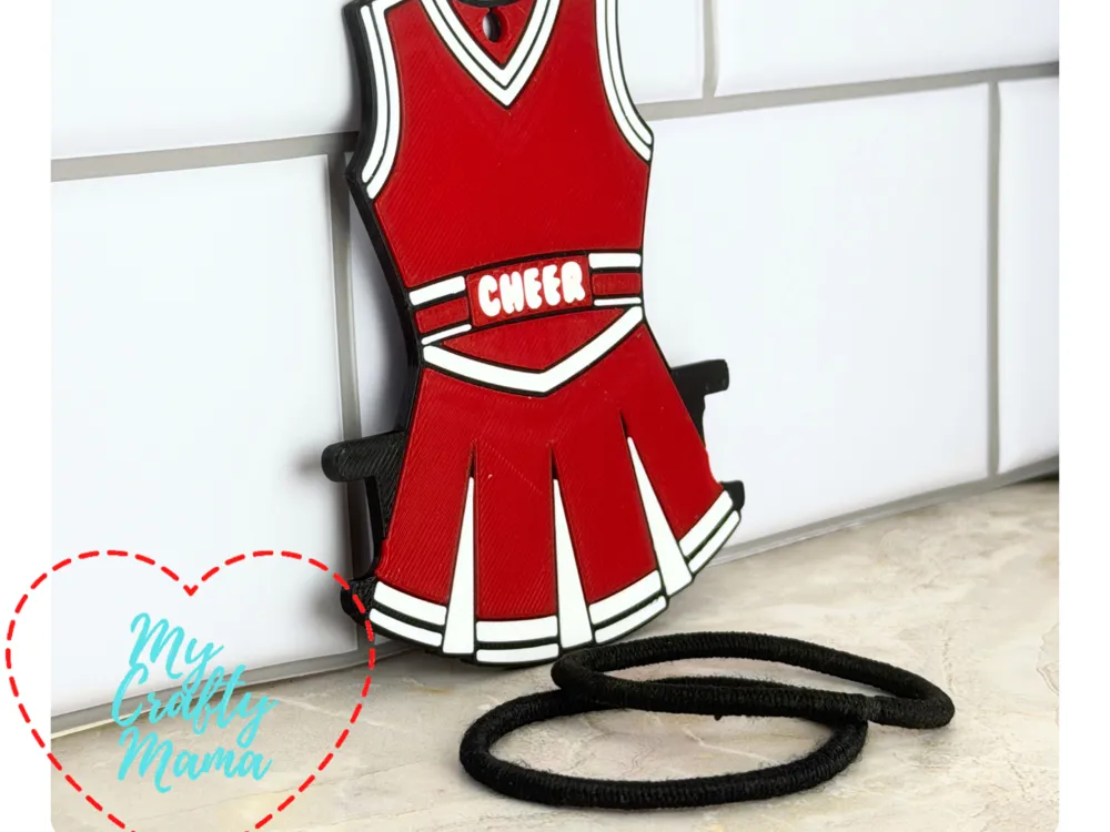 Accesorio para sujetar ligas de cabello: Cheer Outfit Hair Tie Holder Key chain. Referencia del modelo original.