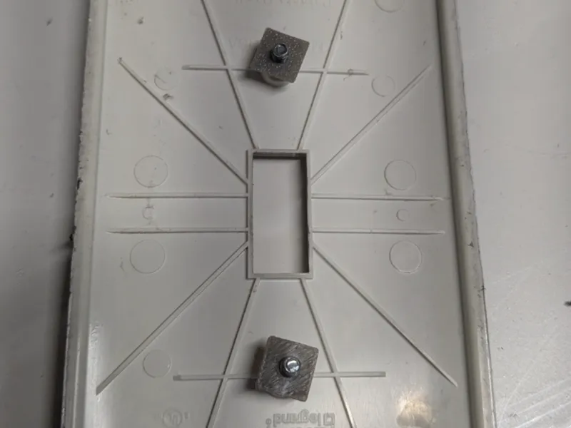 Electrical outlet cover screw retaining washer