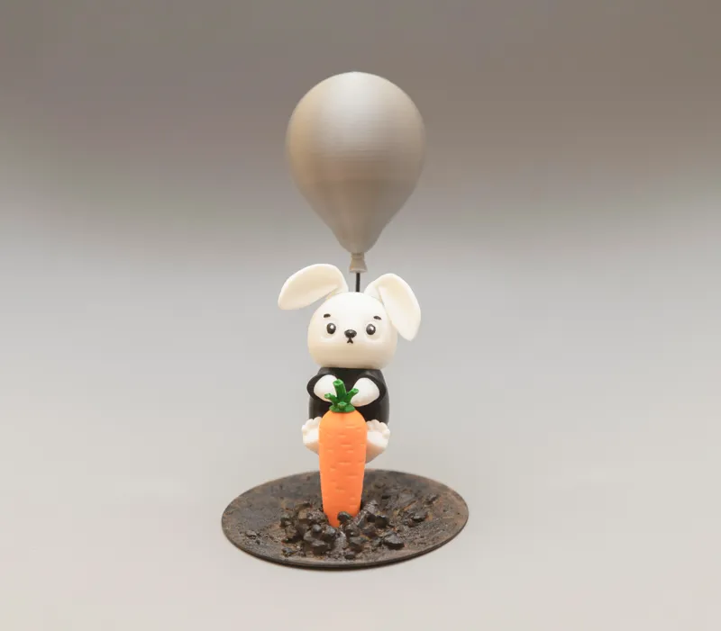 Cute figure of bunny infiltrator flying on balloon