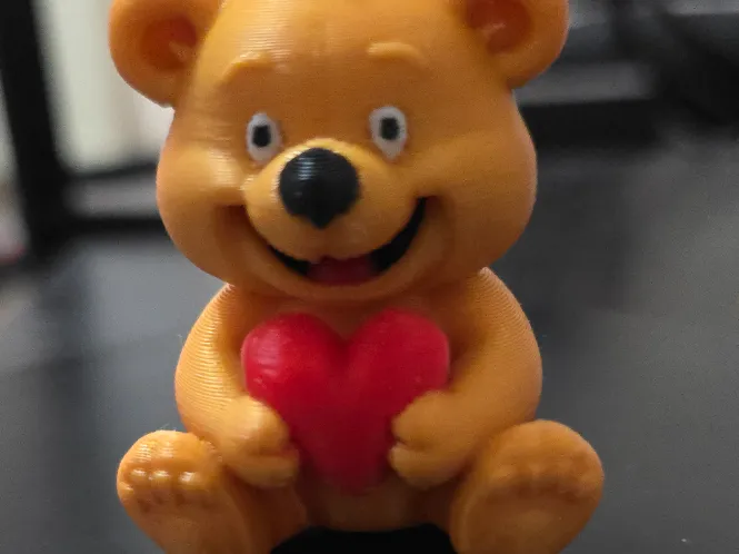 Cute happy teddy bear with hart