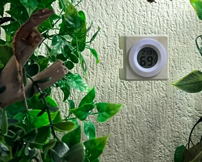Reptile hygrometer/thermometer tank mount holder.