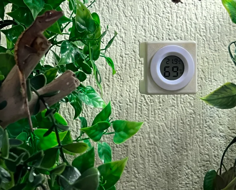 Reptile hygrometer/thermometer tank mount holder.