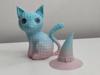 Knitted cat with a witch's hat