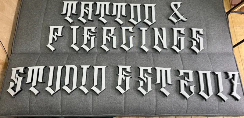 tattoo and piercings studio sign