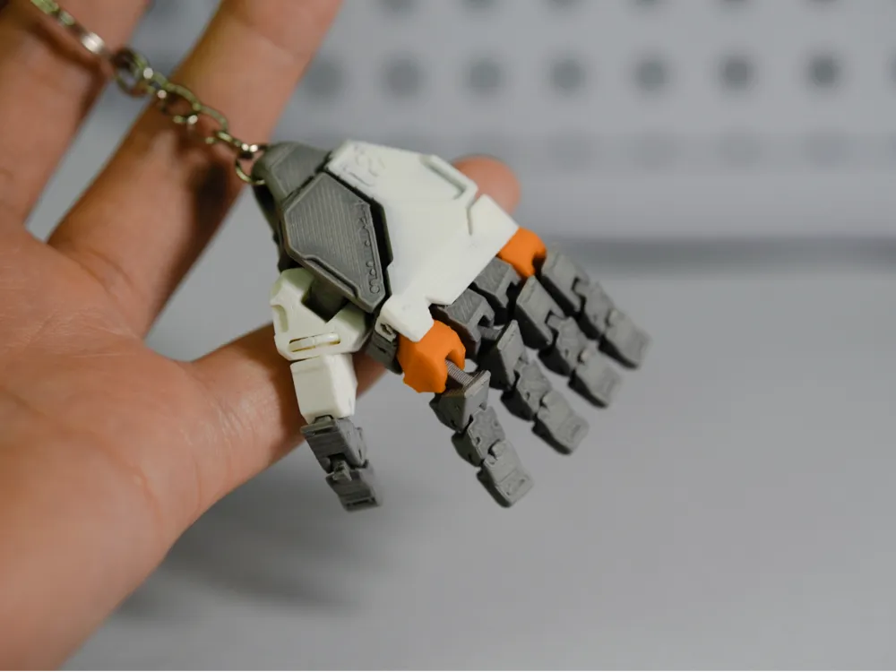 Accesorio para impresora 3D: single‑piece print - Mini‑Mechanical Hand - AMS. Referencia del modelo original.