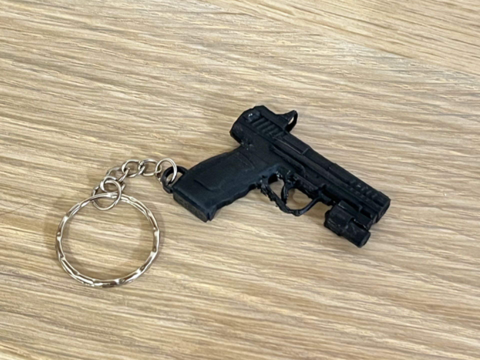 Llavero pistola con linterna y mira táctica