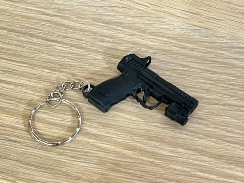 Llavero pistola con linterna y mira táctica