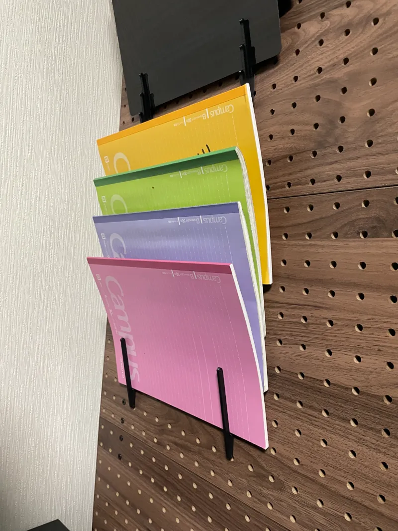 Notebook holder for pegbord