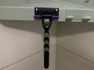Razor holder for shower shelf