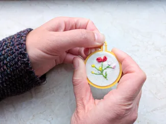 Mini embroidery hoop necklace with closed back