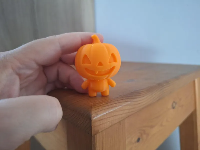 cute pumpkin figure with a face and 1 tooth