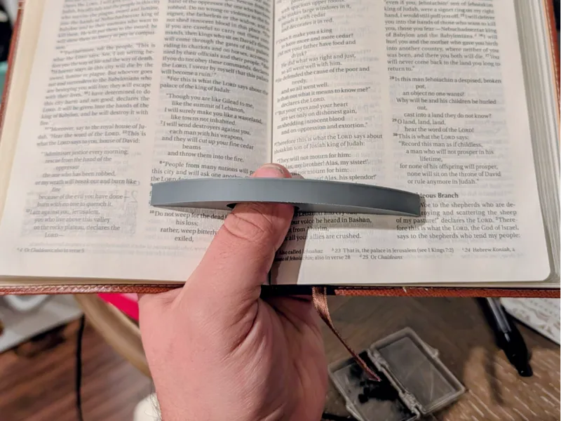 Single point book page holder