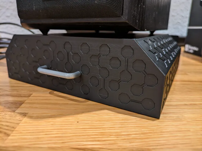 Small drawer under PC speaker with hexagon pattern